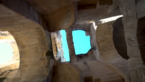 view inside the ruins of the amphitheater. the camera is spinning from the bottom up. ancient roman ruins. ancient amphitheater located in el jem, tunis. historic landmark.