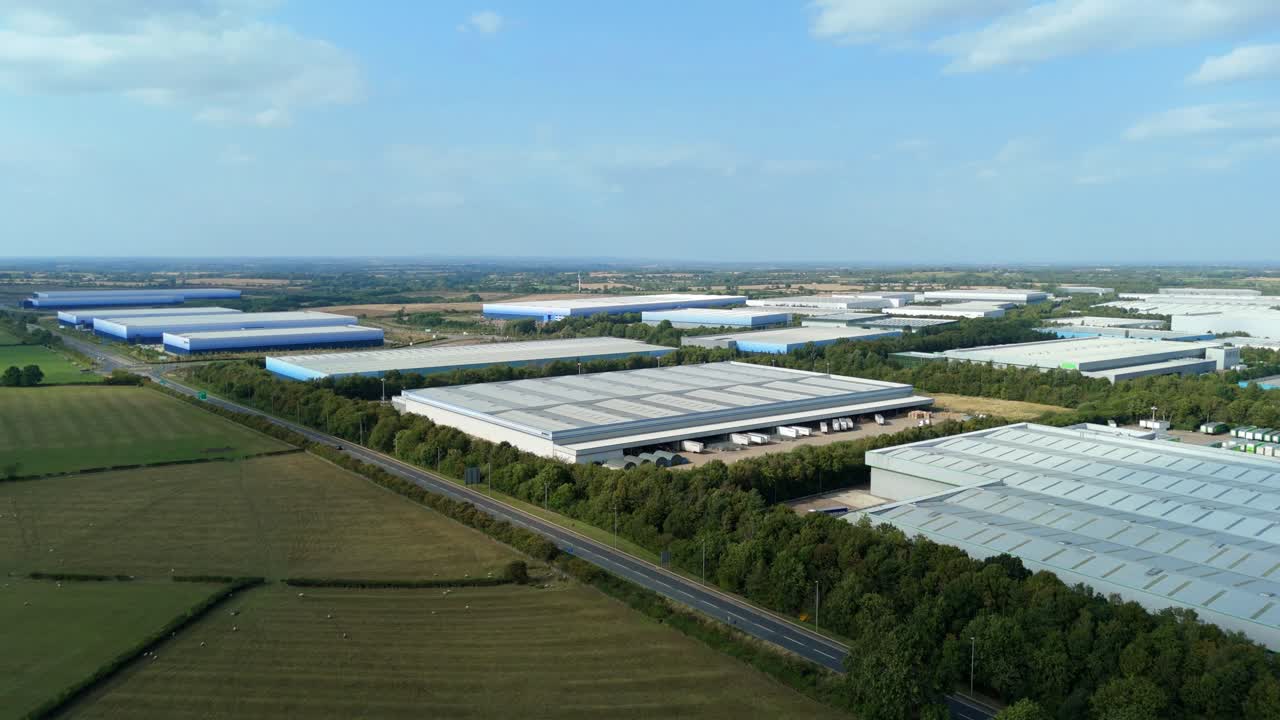Summer evening drone shot of large industrial park Magna Park Lutterworth England UK with warehouses factories distribution centres and retail logistics