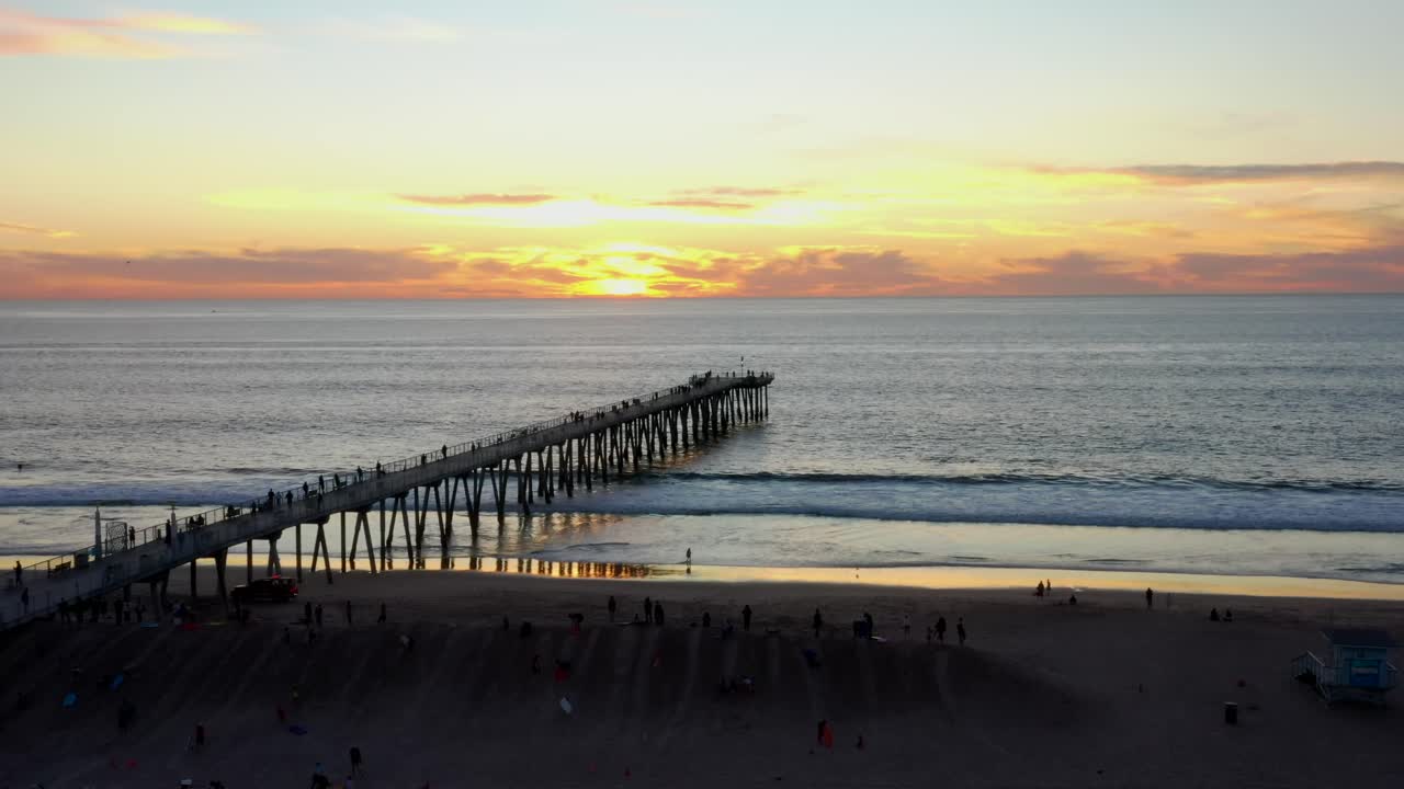 Panorama Of Sunset Setting In The Ocean From The Hermosa Beach With Pier In California. - aerial