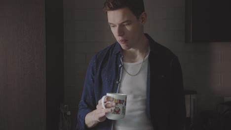 man drinking coffee or tea in the mug - close up