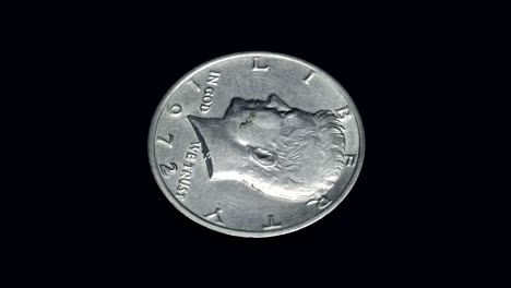 american coin half dollar 1972 release rotates on a black background. macro. closeup