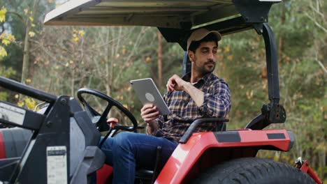 farmer using tablet on tractor