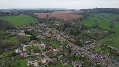 bourton on the hill cotswold village uk high angle panning drone aerial view