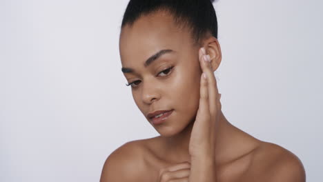 portrait beautiful african american woman touching face with hands caressing smooth healthy skin complexion enjoying perfect natural beauty on white background