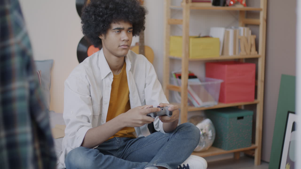 Teenager Playing Video Games in Bedroom