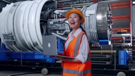 Female Engineer working on a Jet Engine in a Factory