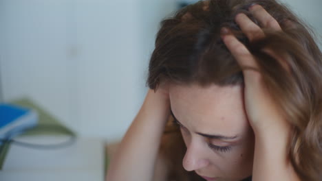 sad and worried woman holding face