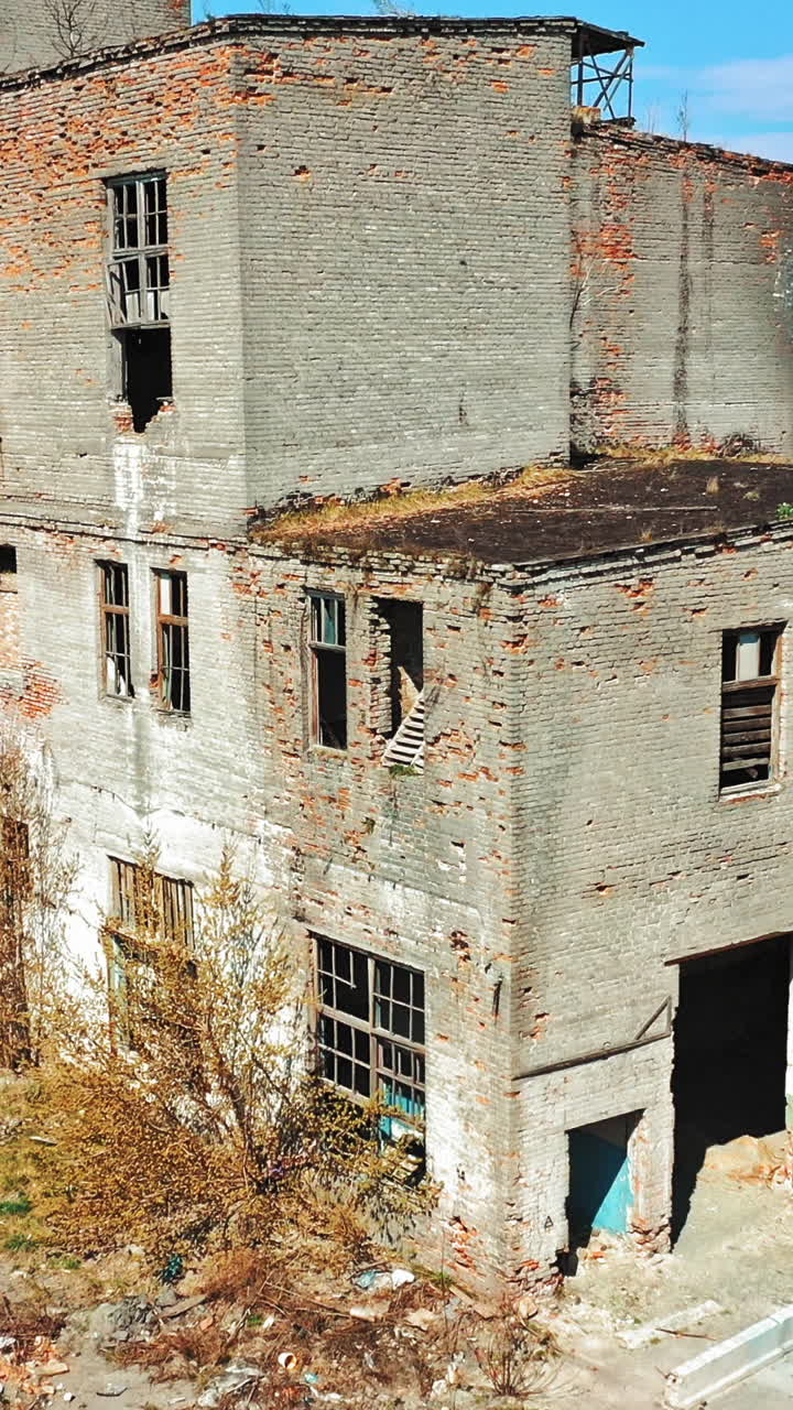 Abandoned ruined industrial factory building, ruins and demolition concept. Aerial view Vertical video