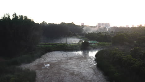 a large truck drives through a wetland area during the early morning near homebush, sydney australia