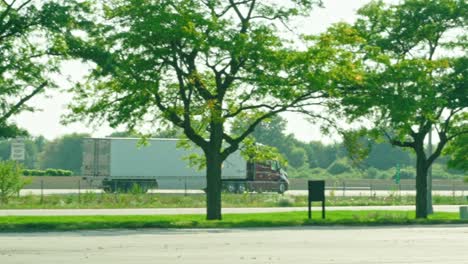 Slow-motion-of-a-red-semi-truck-trailer-driving-on-interstate