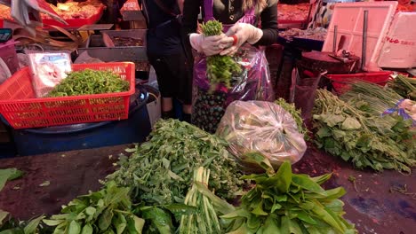 workers packaging fresh vegetables at a market