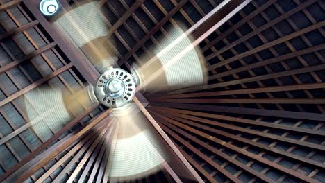 ceiling fan spins under wooden villa ceiling at tropical resort, ceiling fan is a mechanical fan mounted on the ceiling of a room or space,