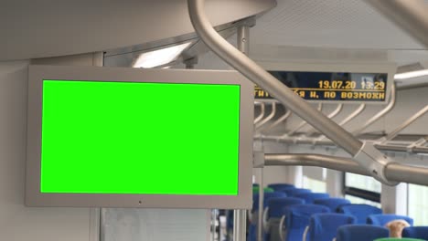 metro train with green screen information monitor to include advertising