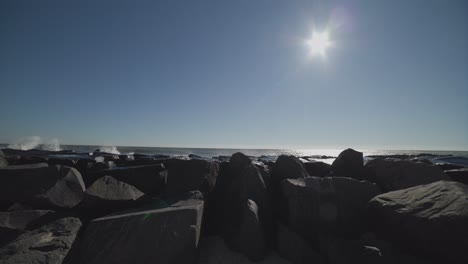 Waves-crashing-against-a-beach-jetty