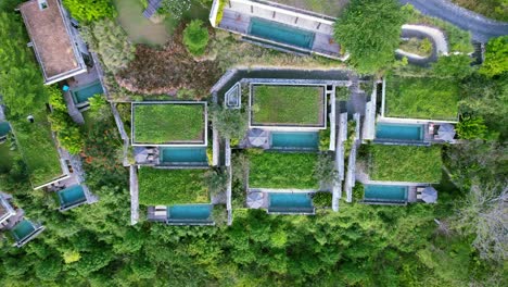 nested terraced villas on hilltop at maua resort in nusa penida klungkung regency, bali indonesia - aerial top down pan