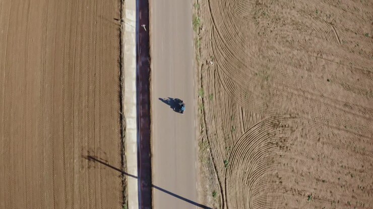 Top Down Aerial View of Motorcycle Rider in Empty Countryside Road, High Angle Drone SHot