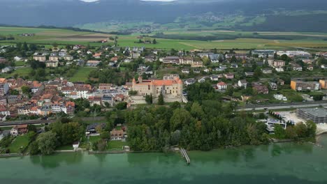 orbit drone shot of grandson castle with lake neuchatel in canton of vaud in switzerland