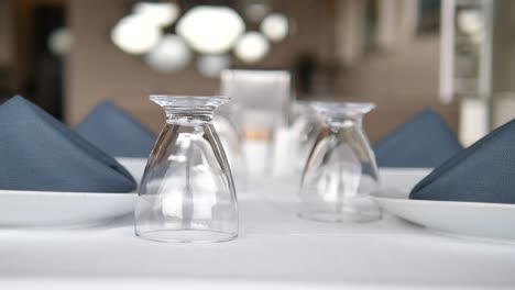 table setting with white tablecloth and glassware