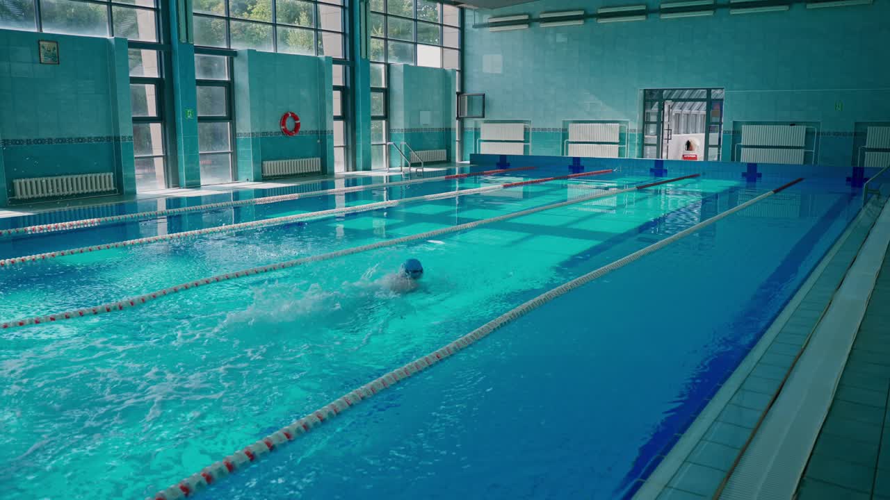 People Swimming in an Indoor Swimming Pool