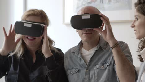 closeup shot of excited mature people testing vr glasses