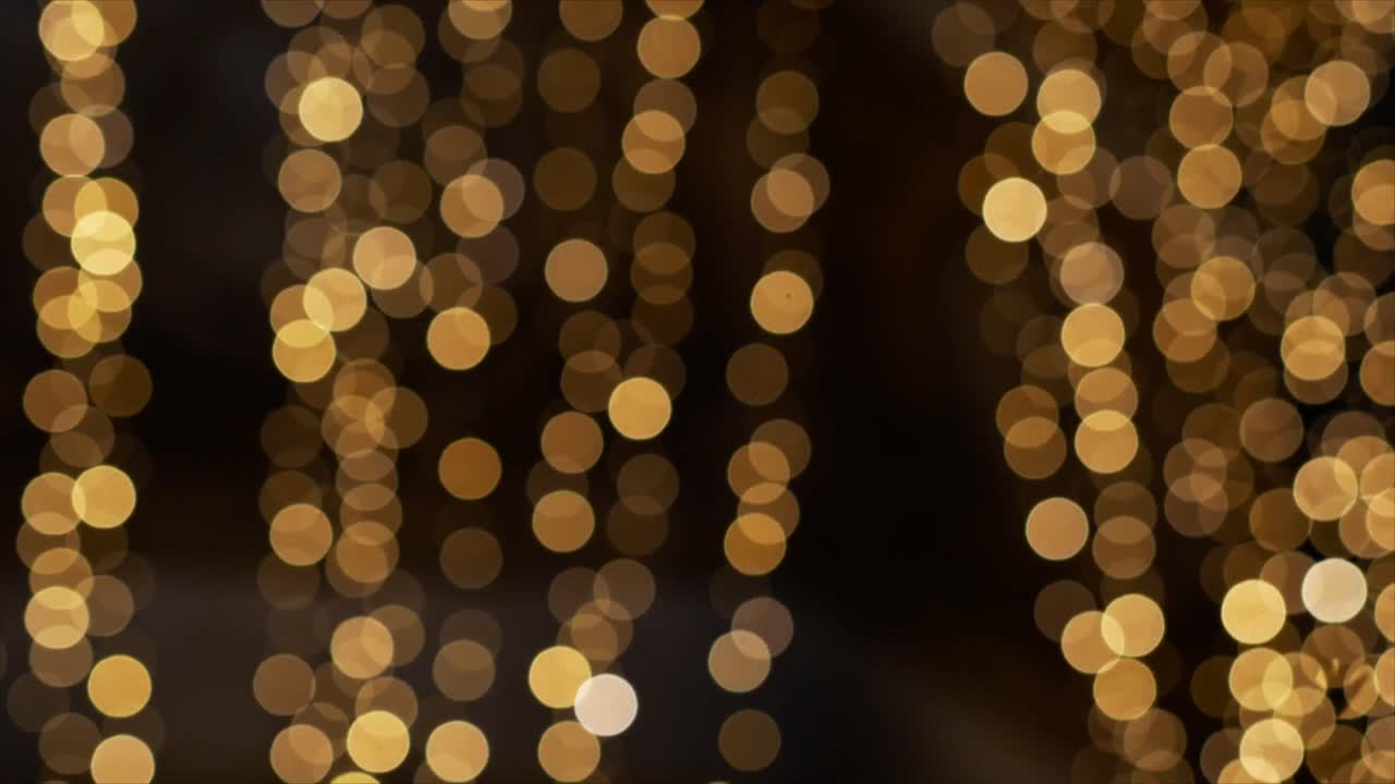 Abstract Golden Bokeh Lights Shimmering on Dark Background