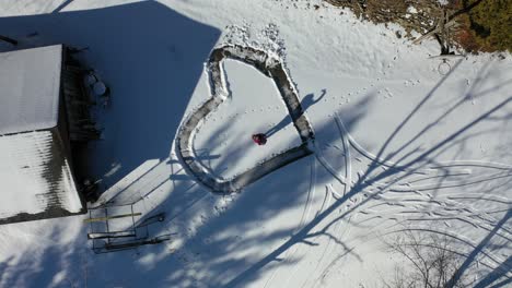 heart-shaped snow path with person in winter