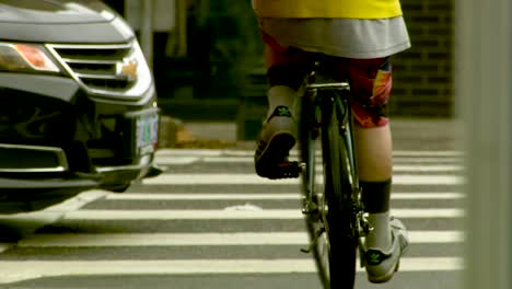 bicyclist waiting at a crosswalk and then crossing the street