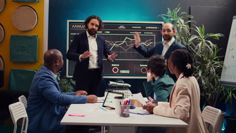 Team-leader-entering-the-meeting-room-and-talking-sense-into-his-employees