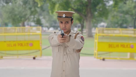 Serious-Indian-police-officer-aiming-with-his-gun