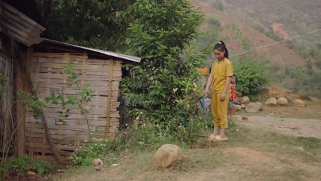 girl watering plants in a rural village