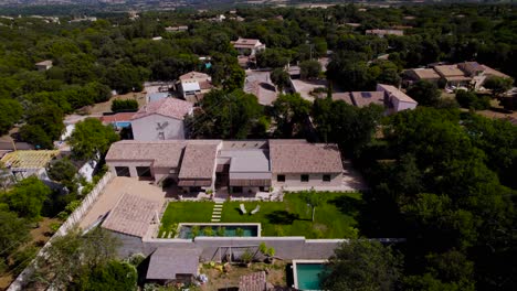 drone rotation of a magnificent provençal house with its small garden, deckchairs and bali stone swimming pool