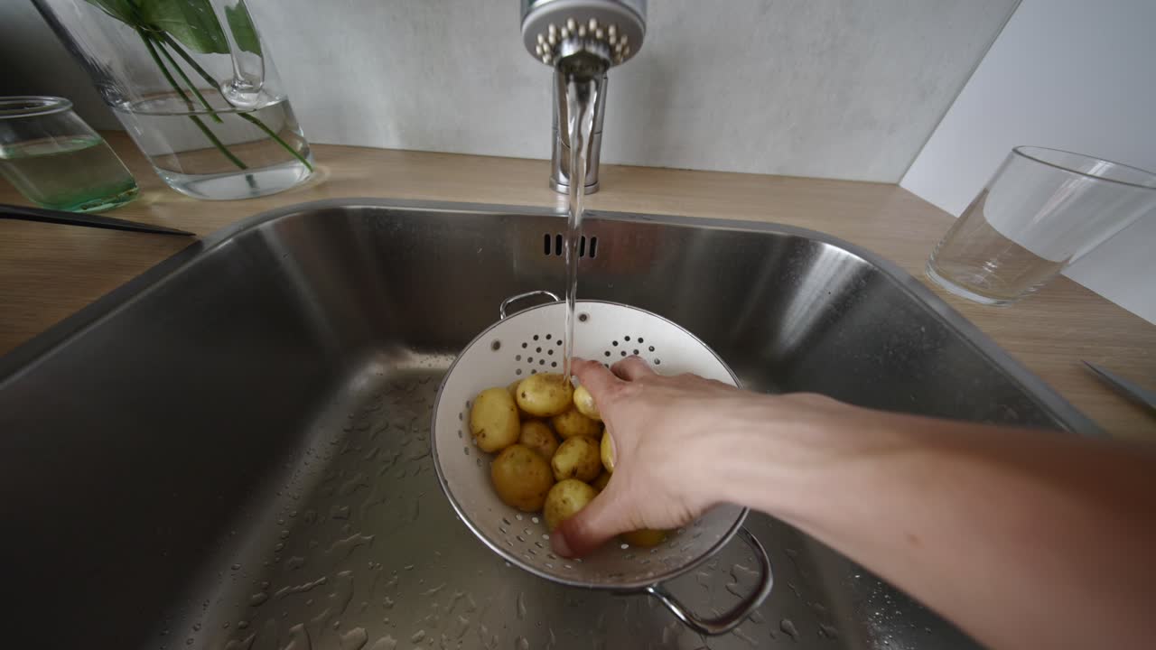 lavar batatas numa pia da cozinha
