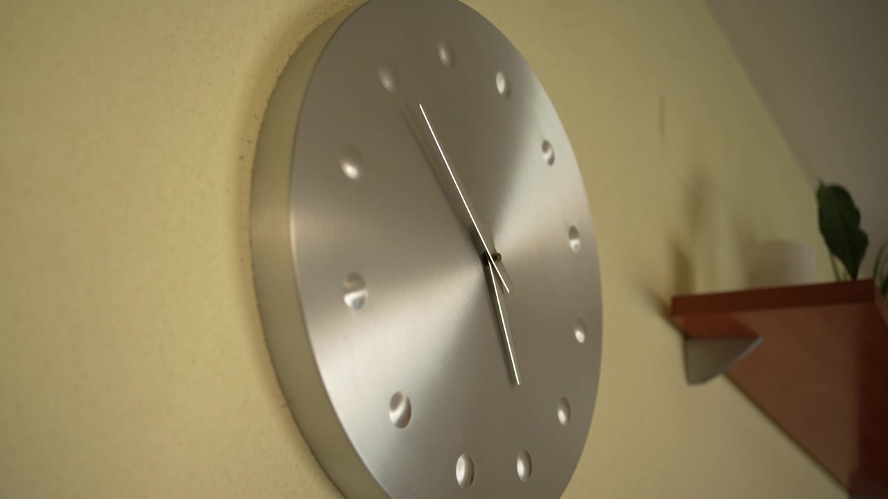 This is a contemporary wall clock that features a sleek and stylish minimalist design