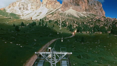 flight along the cables of the sassolungo - langkofel cable railway bringing hikers and other tourists on the top of the mountain