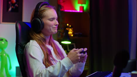 young woman playing video games at home