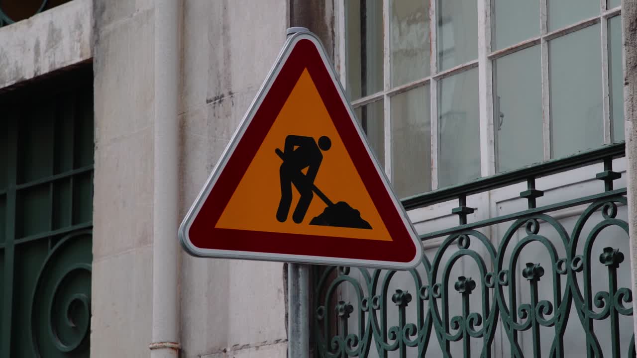 Portuguese Construction Traffic Sign with building behind