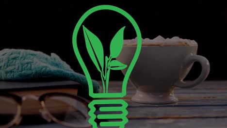 Animation-of-green-lightbulb-over-cup-of-coffee-on-black-background