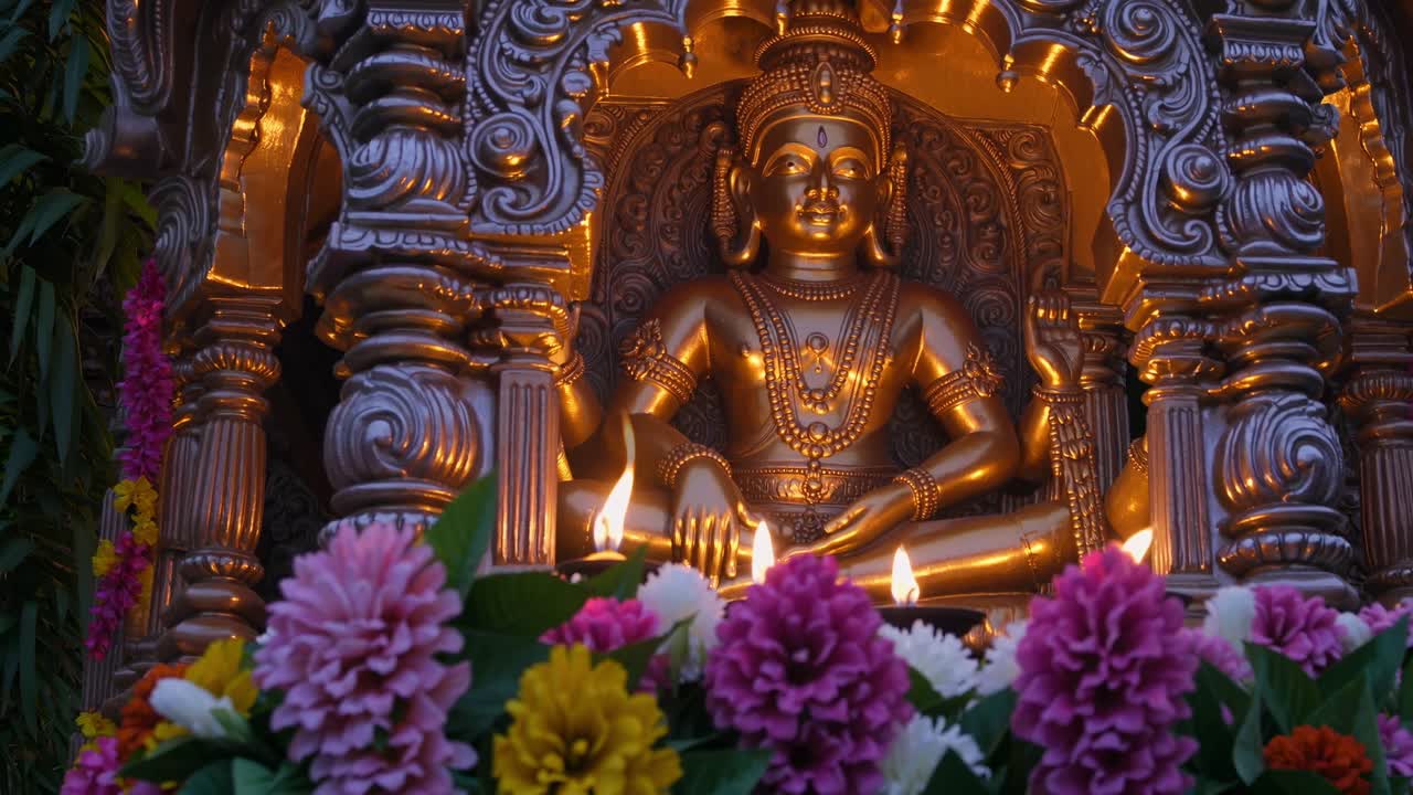 Golden statue illuminated by soft candlelight, surrounded by vibrant flowers, captures the serene ambiance of a spiritual setting with intricate details