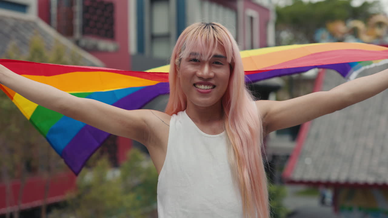 Portrait of a Person with Pink Hair Holding a Pride Flag