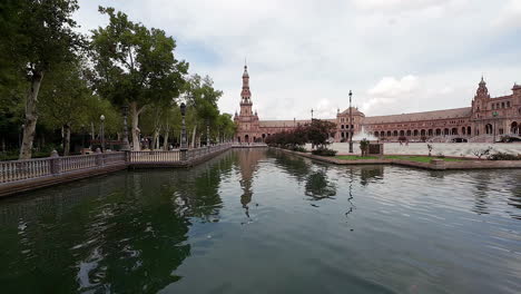 una foto de turistas en botes en la plaza de españa a lo largo de la plaza española en sevilla, españa, en una noche nublada