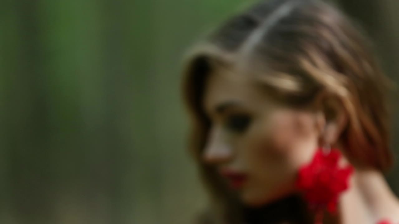 Young Beauty Girl Touching Leaf. Young beauty girl touching leaf in summer forest. Close up of female hand. Concept of nature, environment care