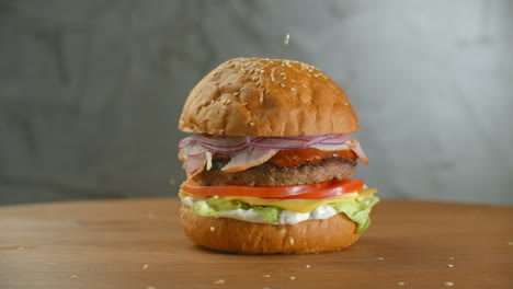 White-sesame-seed-falling-into-bun-in-slow-motion.-Bun-with-sesame-for-making-hamburger