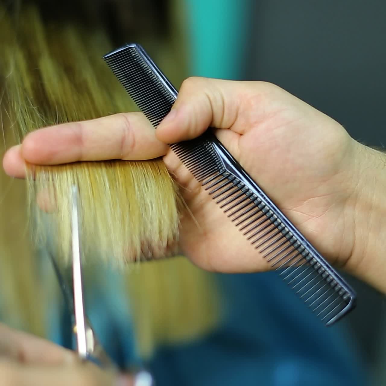Hairdresser cutting hair of her customer