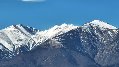 snow covered pyrenees mountains aerial shot sunny day