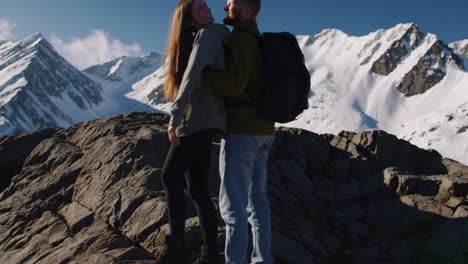 couple hiking in majestic snow-capped mountains