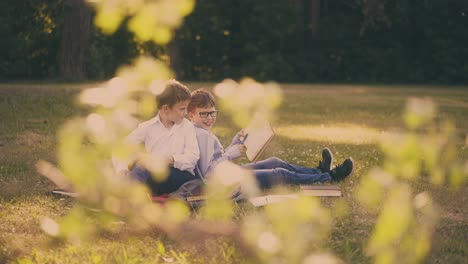 cute-kids-prepare-for-school-test-with-books-sitting-in-park