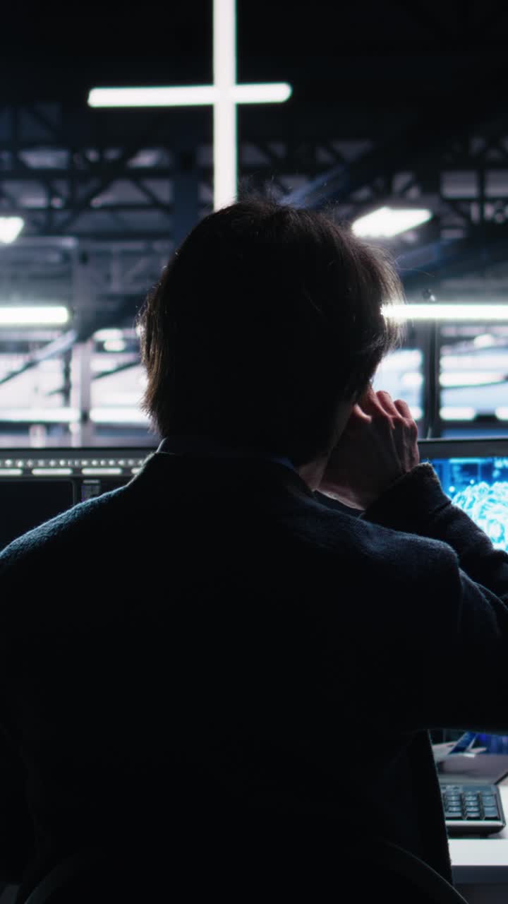 Vertical video Data center engineer using computer to monitor neural network AI LLM