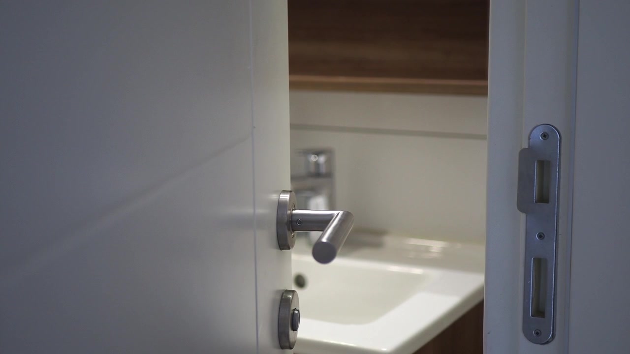 Close-up of a White Door Opening to a Bathroom