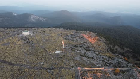 Aerial-forwarding-shot-over-mountain-Tlaloc-with-sun-rays-falling-on-the-mountain-at-sunset-in-Mexico