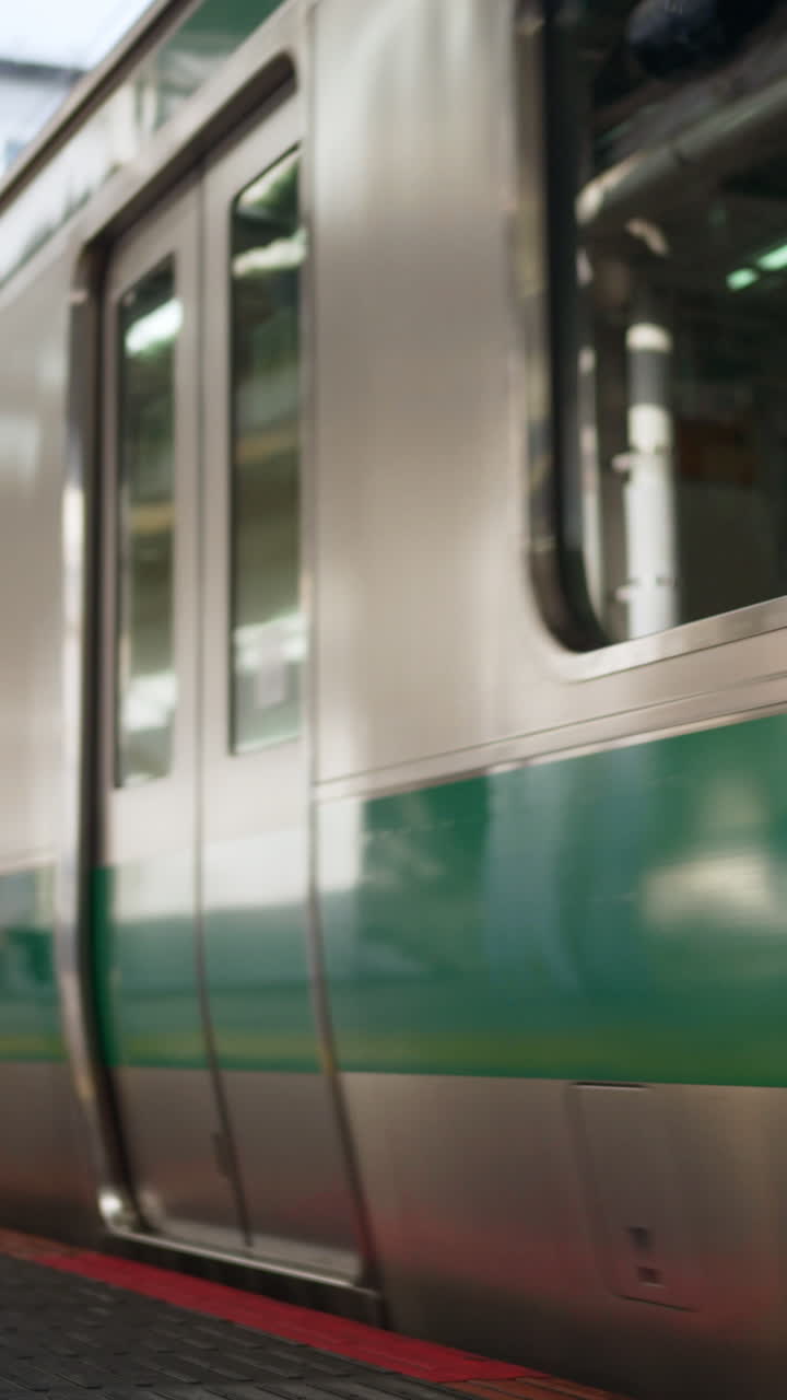 Close up of a subway arriving at the station in Tokyo, Japan. Vertical